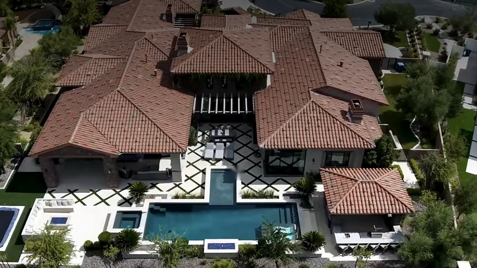 Aerial view of a large Las Vegas estate with a courtyard, pool and tile roof
