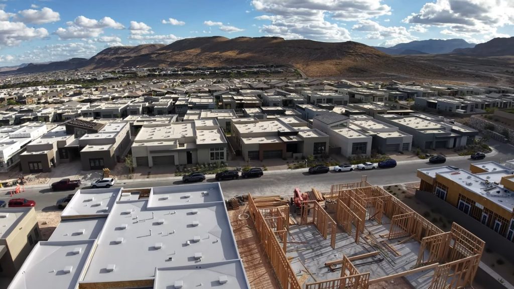 Aerial view of new homes under construction in Summerlin with the Red Rock foothills behind